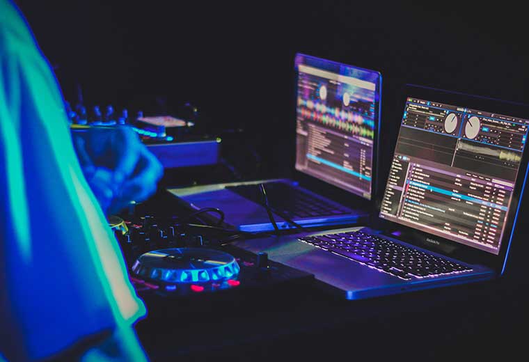 dj using computers at an event