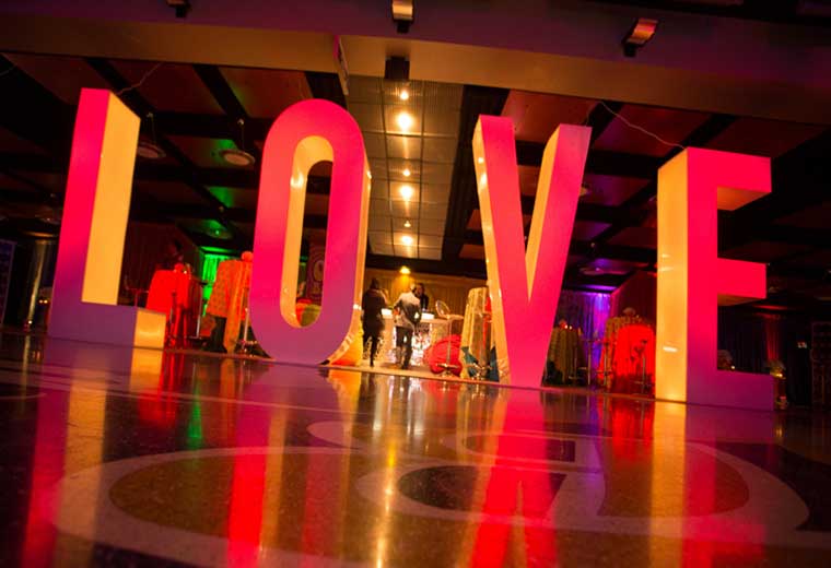 fun activation that says "LOVE" in red light at an event