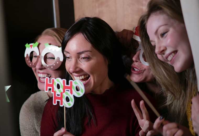 women using a photo booth at an event